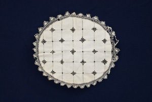 Oval shaped cream linen with openwork and lace.