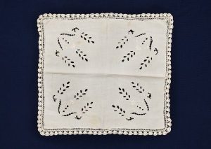 Rectangular cream linen with openwork and lace.