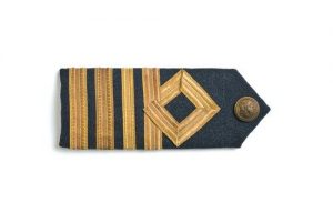 Blue wool epaulet with four gold stripes and Air Force button, belonged to David Edgar Allalouf (1918-2003).
