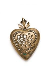 Gold, crystal back, heart shaped locket with five diamonds and two emeralds