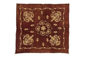 Reader's desk cover (?), faded maroon velvet, gold embroidery, central floral ornament, corner motifs and floral border.