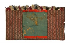 Tik (Torah case) wrapper, cotton in brown shades, with geometric design in vertical stripes, fringe trim at upper border, without centrepiece.