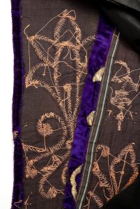Tik (Torah case) wrapper, gold laid and couched embroidery on purple silk velvet, made from an Ottoman-style festive dress, used to decorate the Tik held by the Hatan Torah (Bridegroom of the Torah), rear side detail.