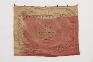 Tik (Torah case) wrapper, partly faded pink silk with laid and couched gold embroidery, central ornament and foliate border, probably cushion cover in secondary use.