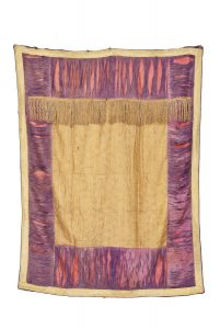 Torah ark curtain, wheaten silk brocade centrepiece with gold fringe trim at the upper rim, broad violet silk borders (worn), edged with woven gold braid.