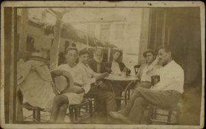 Six men sitting in café.