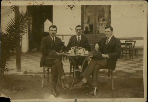 Three young men in a café.