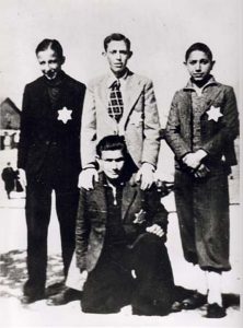 Four friends wearing the Yellow Star, have their picture taken in the Baron Hirsch ghetto