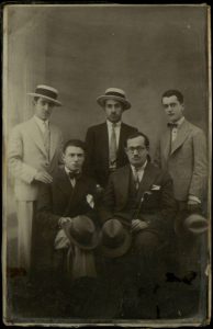Two men sitting, three standing, sitting on right- Joseph Eligia, Ioannina.