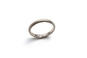 Silver ring inscribed 'D...'.