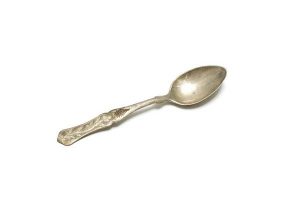 Silver cake spoon with floral engraving.