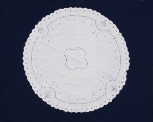 Round white linen cloth with cutout embroidery, dowry of Fakima Allalouf