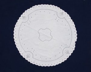 Round white linen cloth with cutout embroidery, dowry of Fakima Allalouf