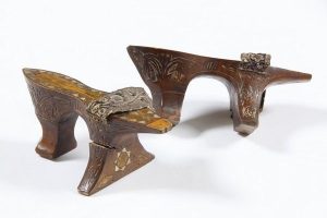 Pair of high-heeled wooden bath clogs, carved decoration, geometric inlay of mother-of-pearl, gold embroidered strap attached to the sole, probably belonged to a member of the the local Jewish community.