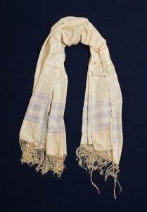 Prayer shawl, white silk with very light blue stripes along the edge, cream square corner reinforcements, belonged to Bohor Yosofat.