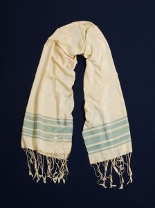 Prayer shawl, handwoven cream silk with pale blue stripes along the edge, initials 
