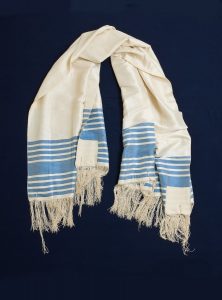 Prayer shawl, white silk with azure blue stripes along the edge, white square corner reinforcements, belonged Isaac Elijah Koffino, Ioannina.