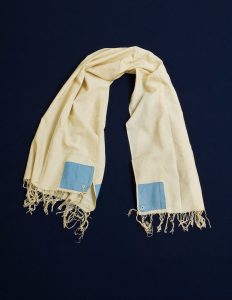 Prayer shawl, cream cotton, light blue square corner reinforcements.