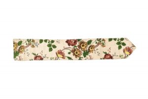 Narrow cream linen band with large scale floral pattern in brown, yellow and green.