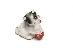 Ceramic kitten statuette, white clay, glazed, with toy ball, used as a toy in hiding during WWII.