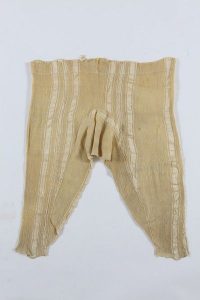 Beige silk crepe with vertical stripes, with drawstring fastening, edged with crochet lace at ankle cuffs, probably belonged to a member of the the local Jewish community.