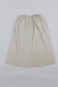 Cream cotton, with drawstring fastening, probably belonged to a member of the the local Jewish community.