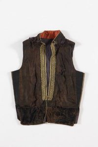 Dark brown silk front, front opening trimmed with braided gold cords, probably belonged to a member of the the local Jewish community.