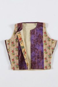 Silk brocade in violet tones at the front, rear side made of white cotton with blue and green stripes, probably belonged to a member of the the local Jewish community.