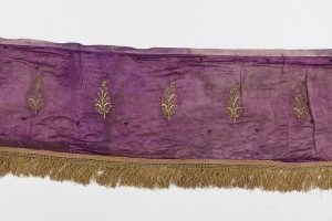 Bimah front cover, purple silk with gold embroidered blossoming branches, with suspension loops.