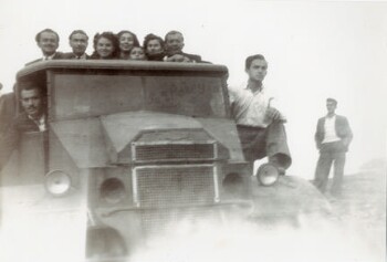 A company of men and women on top of the truck