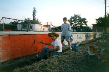 Bill, a young painter, paints playgrounds at Kefalochori village