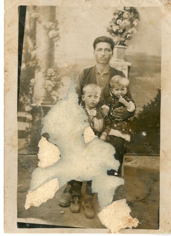 Memorial photo of son and niece on the father's lap