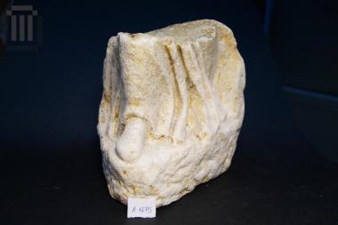 Part of a statuette-acroterion (architectural-building element)