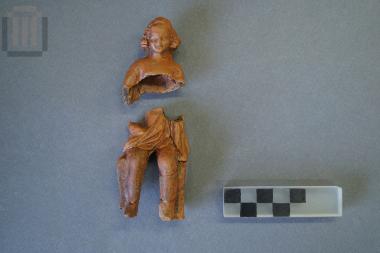 Parts of a figurine of a seated child