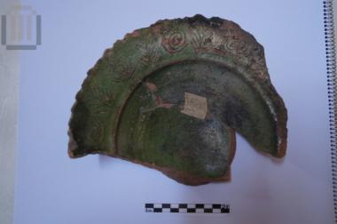 Part of a glazed plate with incised decoration