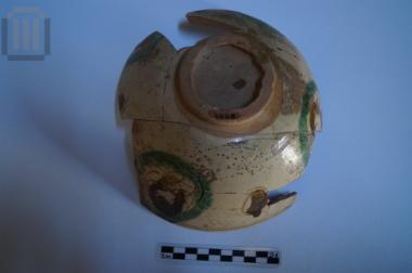 Part of a glazed bowl with painted and incised decoration