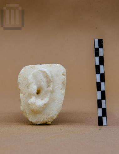 Dedicatory marble plaque depicting an ear in relief