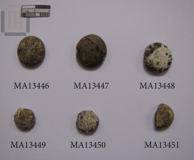 Undecorated glass 'ringstone' (board game piece?)