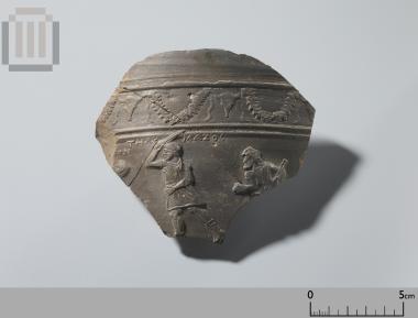 Part of a clay krater with relief scene and inscriptions