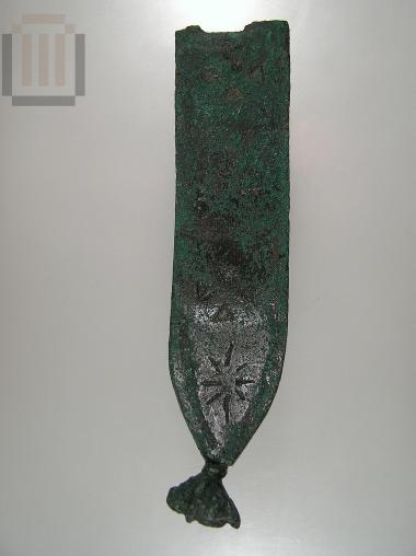 Part of a  human statue 's chest belt.