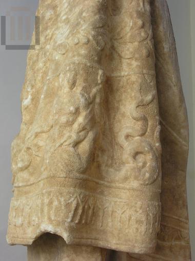 Part of an himation with relief decoration.