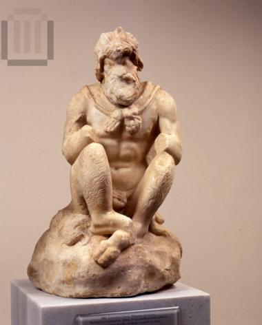 Statuette of  Pan, sitting on a rock.