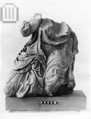 Part of a pediment sculpture  of a kneeling female figure.