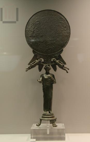 Mirror resting on peplos kore
