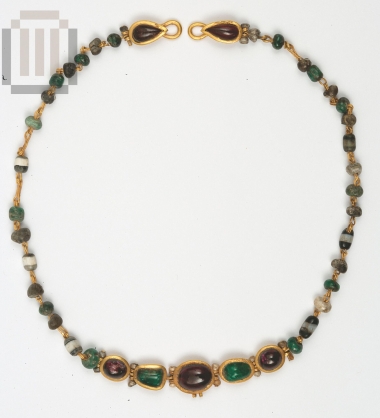 Gold necklace with garnets and emeralds