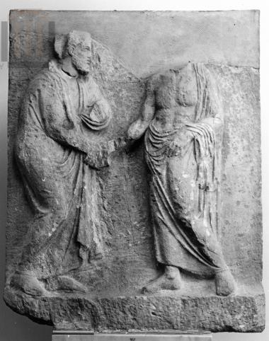 Funerary stele depicting a dexiosis scene between two men.