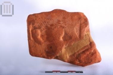 Part of roof tile with relief decoration