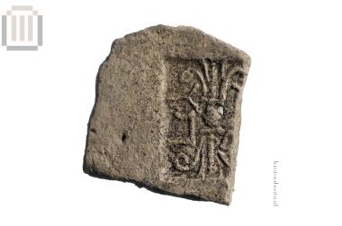 Part of a stamped clay roof tile from Dymokastro