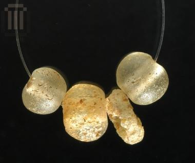 Four quartz and glass beads