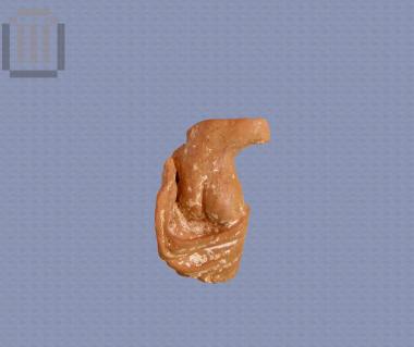 Fragment of clay-figurine of naked female with himation